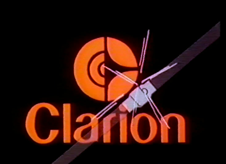 A yellow slab sweeps across black with brushed streaks, orange Clarion roundel sitting below.