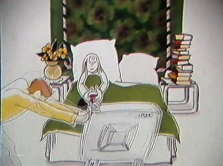 Hän työntää television sängyn ääreen, jossa nainen istuu tyynyjen varassa juoma kädessään.