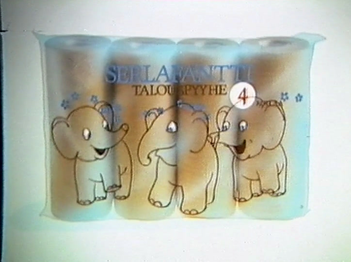 One elephant dips its trunk into the blue puddle while the others look on