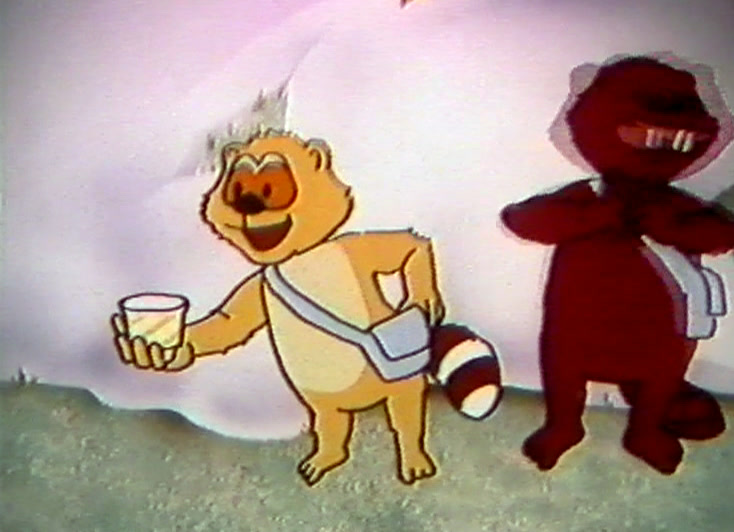 Vaaleanruskea pentu ojentaa valkoista purkkia, punainen majava seisoo kädet puuskassa.