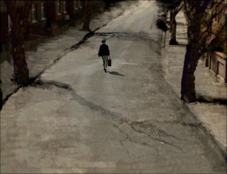 Still from Many Happy Returns, a lone figure with a bag walking away down a snowy street between bare trees